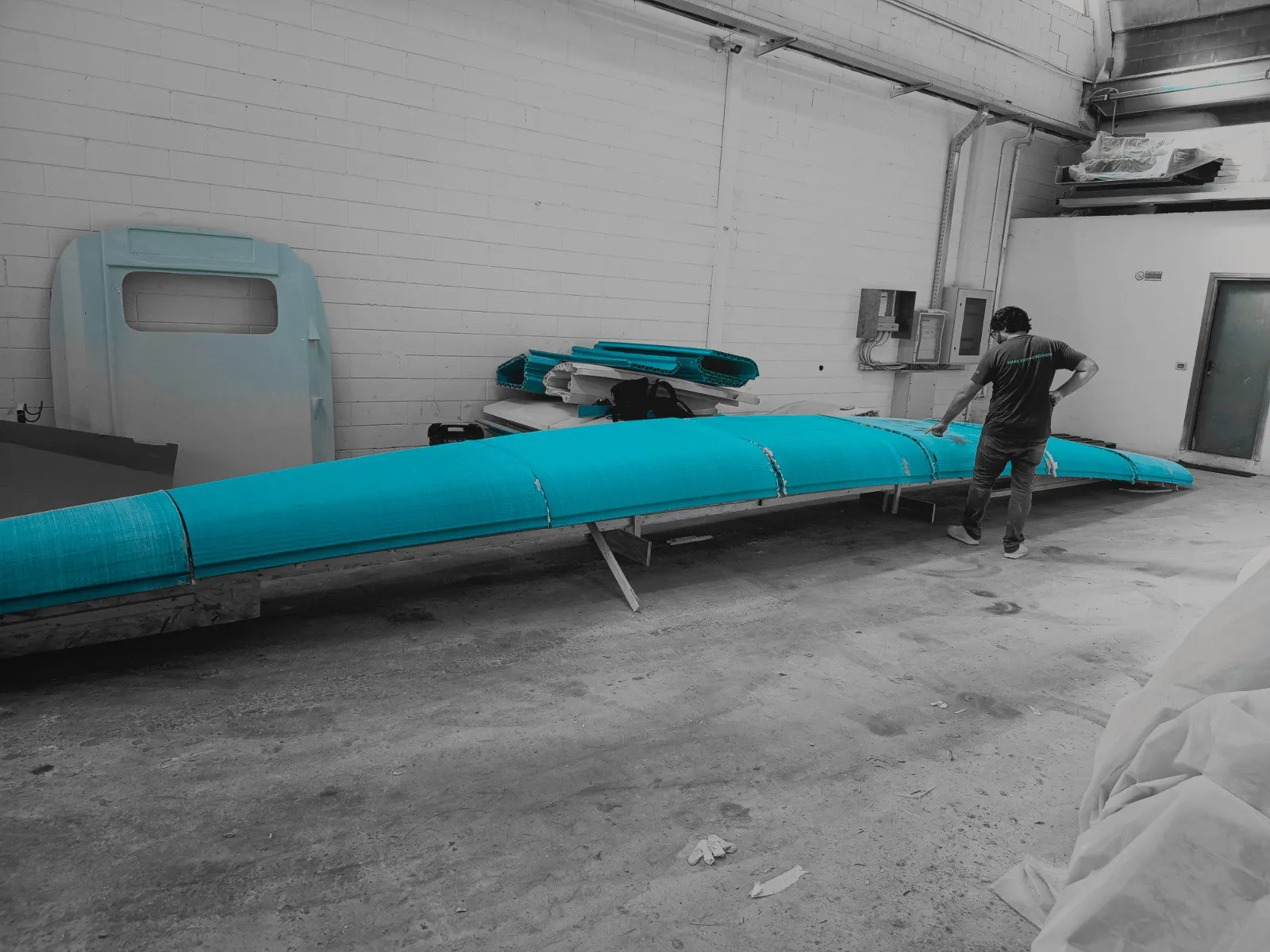 A hull section of the 43 foot catamaran, 3D printed and laminated, in the workshop
