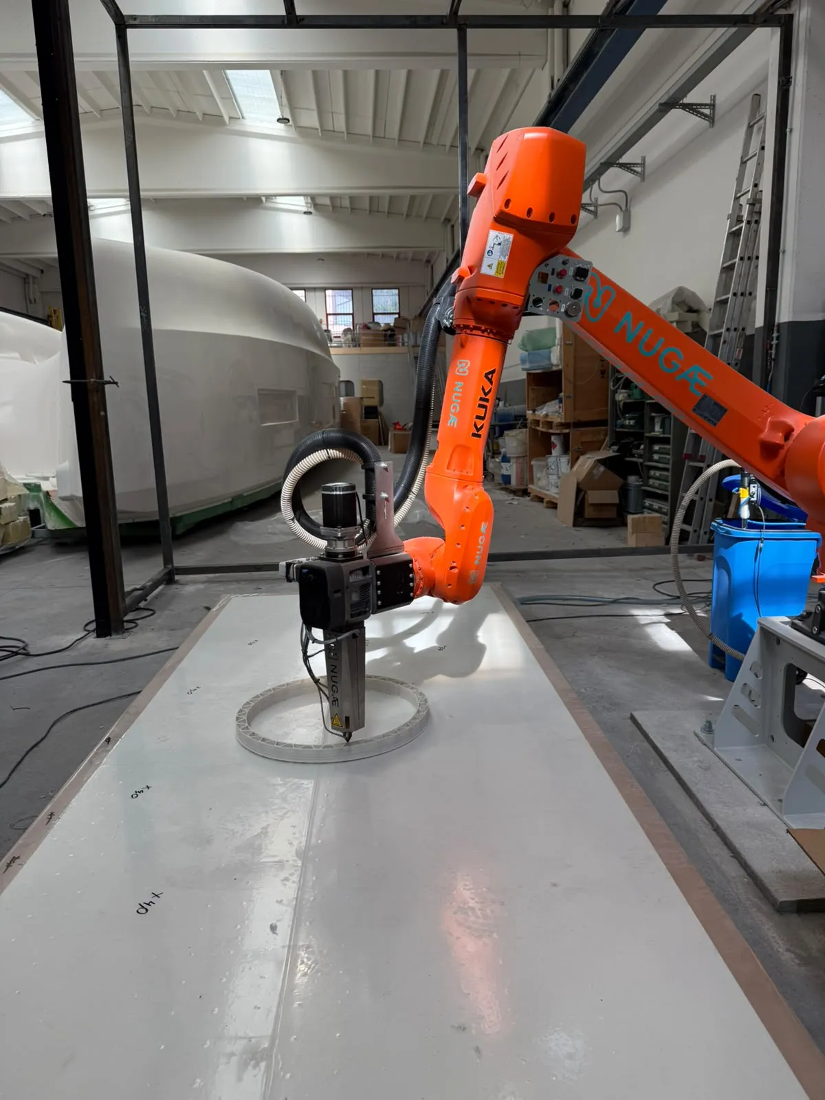 NUGAE robot at work on the print bed in a shipyard